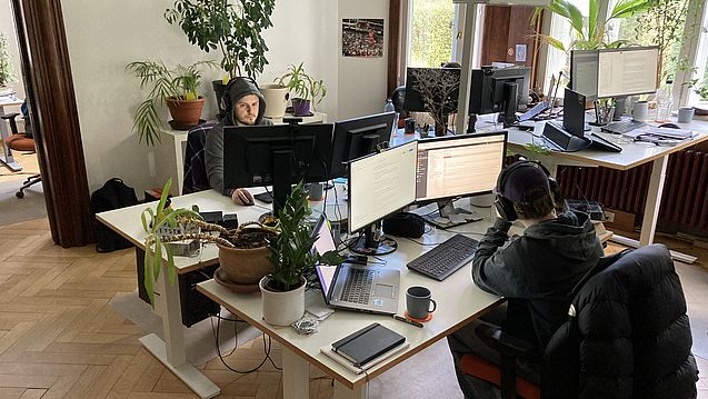 Schreibtisch-Insel im werkraum-Büro mit arbeitenden Mitarbeitern